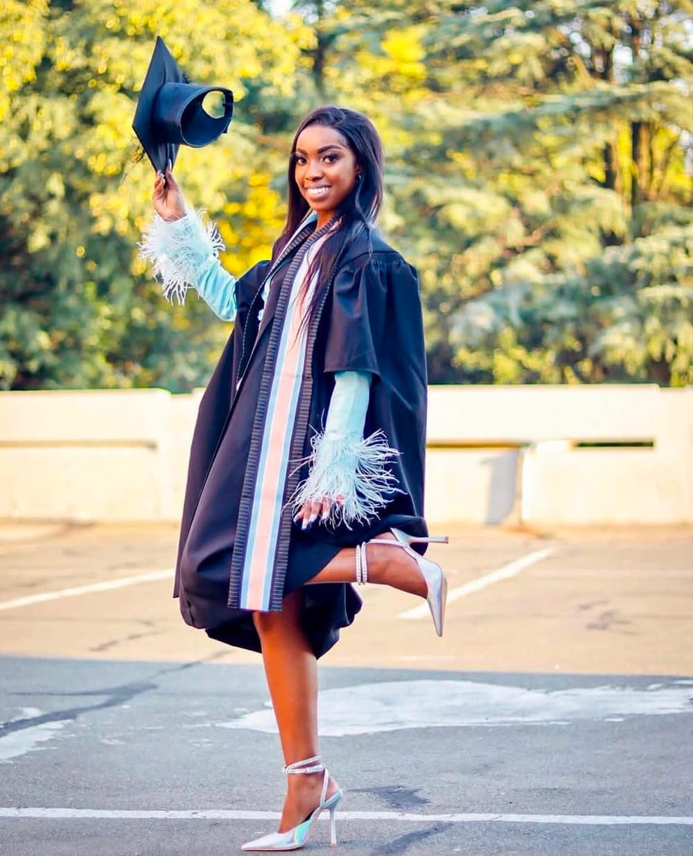 Graduation portrait shoot — cap toss in gown and heels