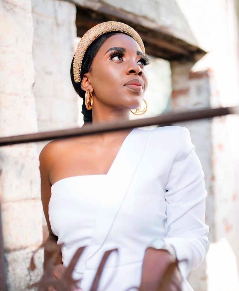 Portrait shoot in a white one-shoulder outfit with a gold headband