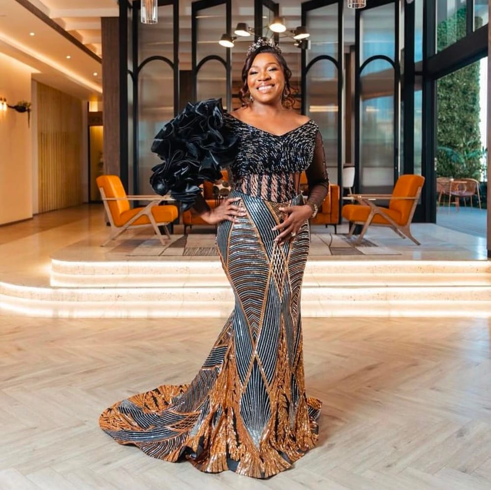 Full-length portrait in a black and gold sequin gown