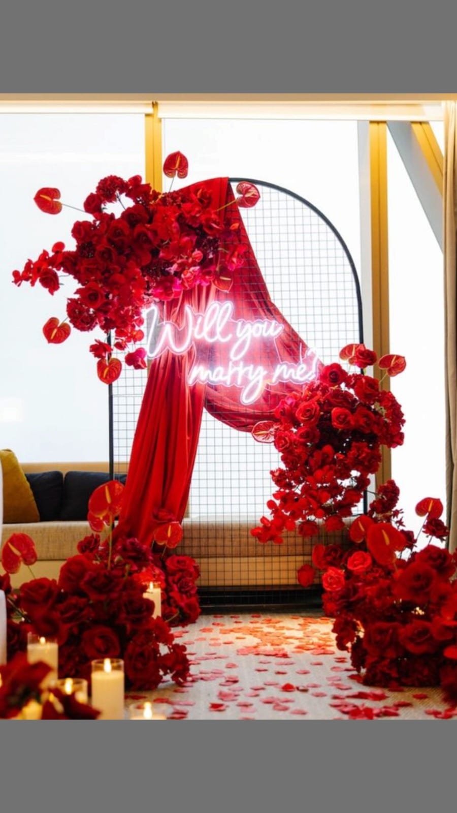 Red neon 'Will you marry me' with roses and candlelight