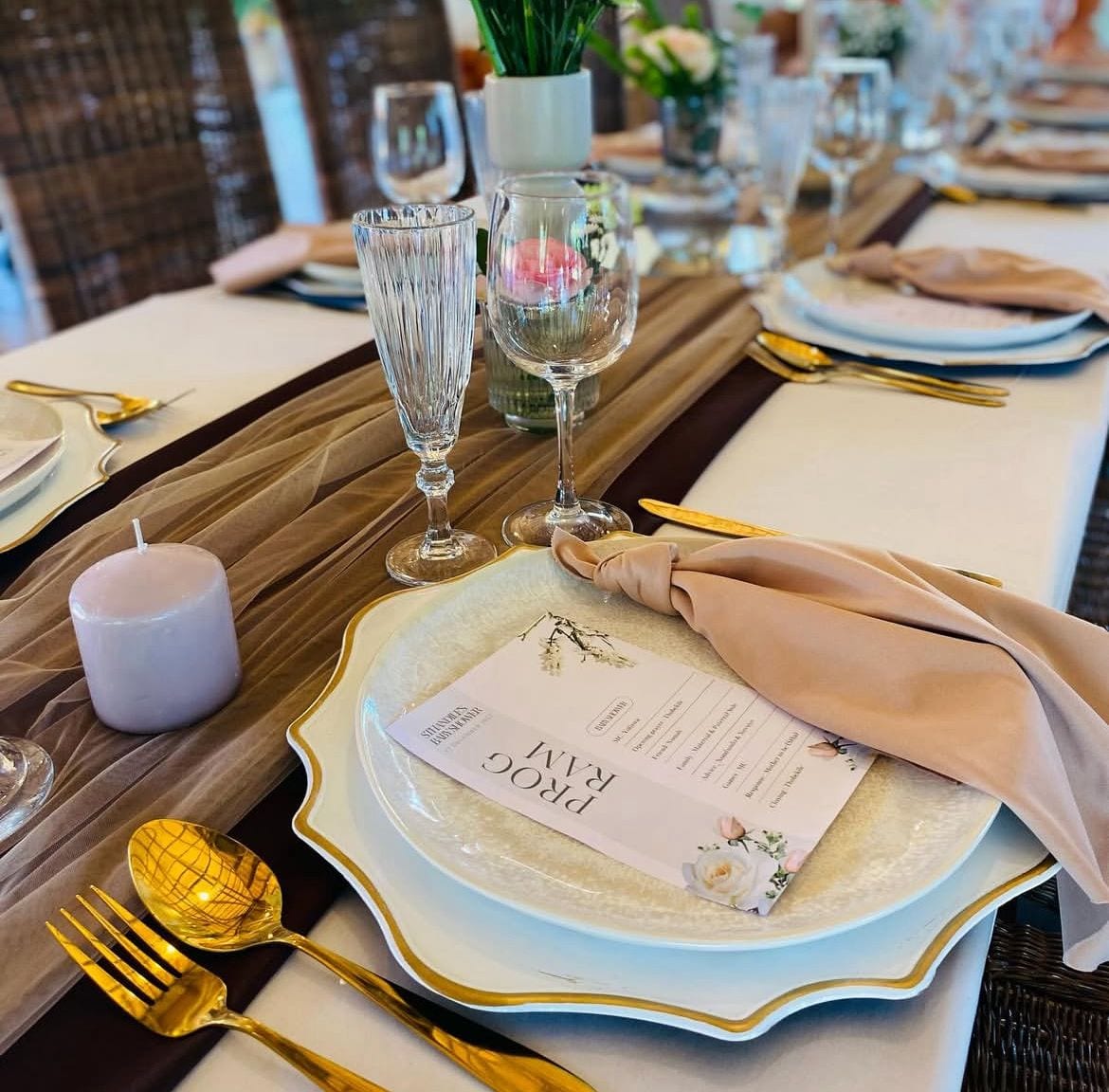 Rustic place setting with gold accents and blush napkins
